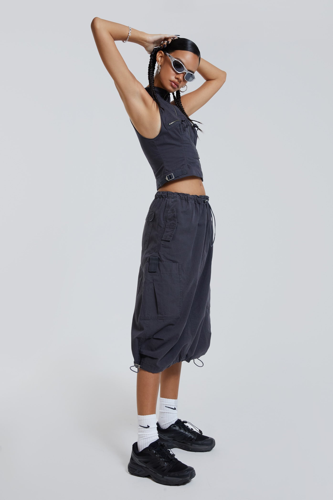 Female wearing grey cargo parachute style maxi skirt. 