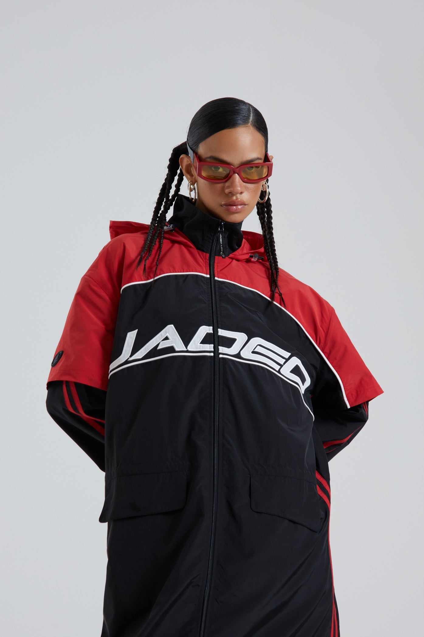 Female wearing red & black maxi length long sleeve sporty cagoule coat.