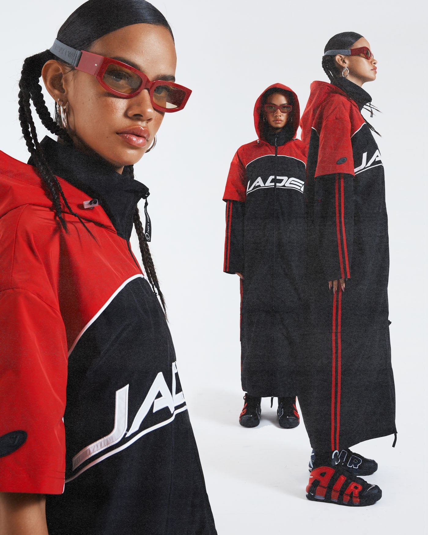 Female wearing red & black knee length long sleeve sporty cagoule coat. 