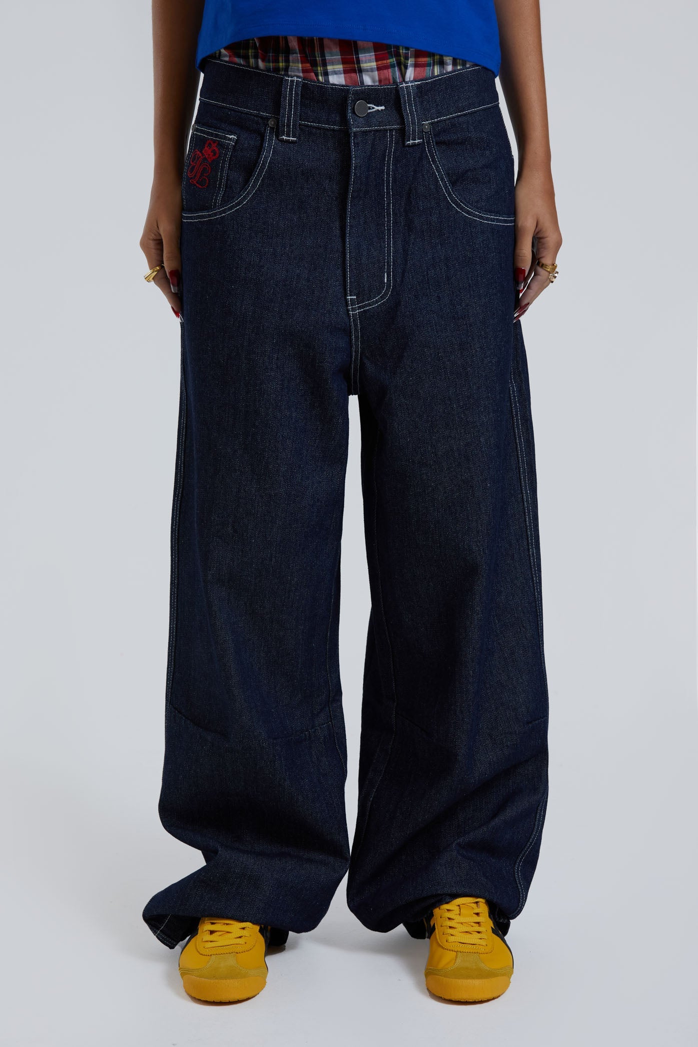 Female wearing sandblast washed denim jeans in an oversized skate fit with embroidered coin pocket and Union Jack artwork across back body and pockets. 