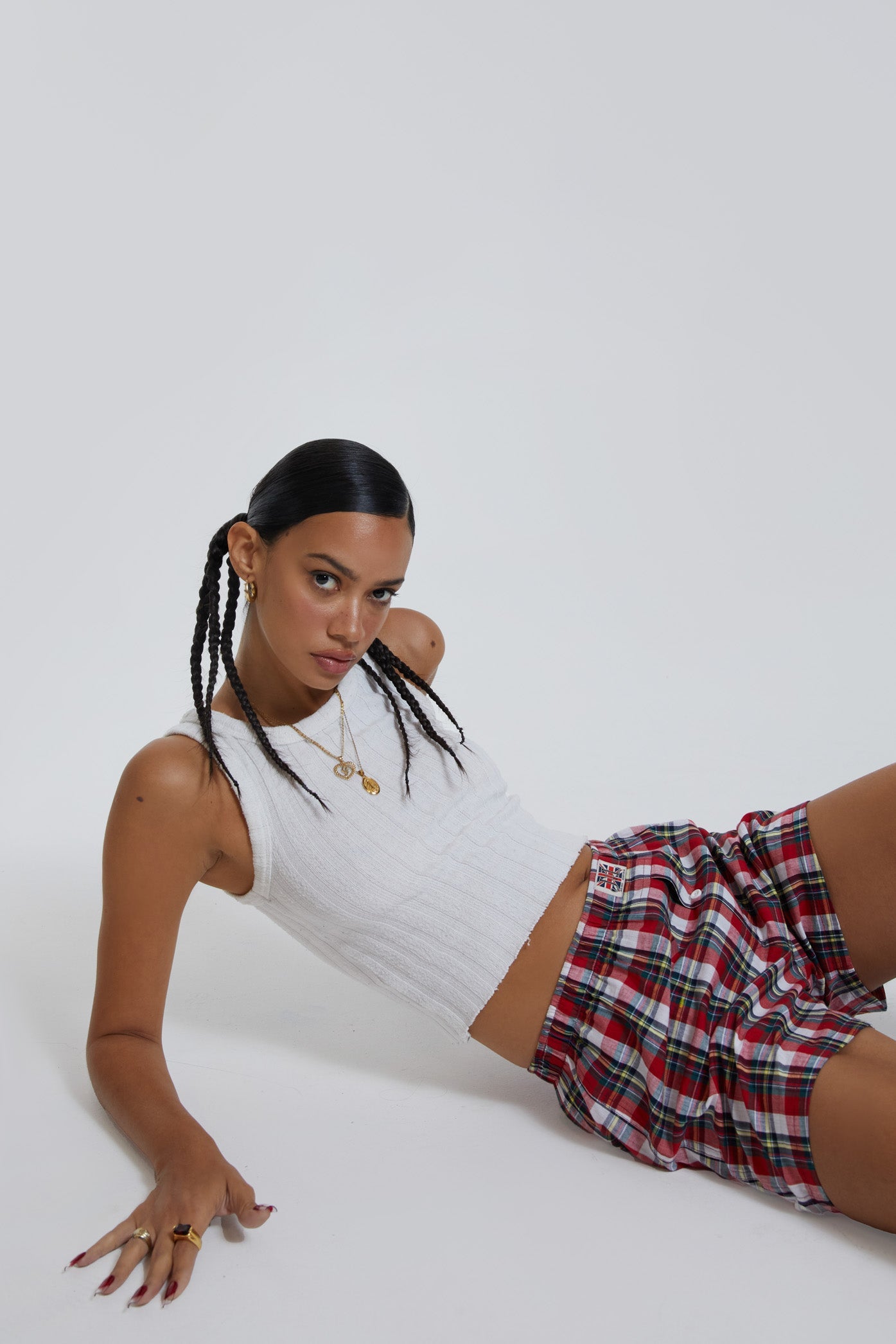 Female wearing multi coloured tartan printed boxer shorts with Union Jack woven label detail.   