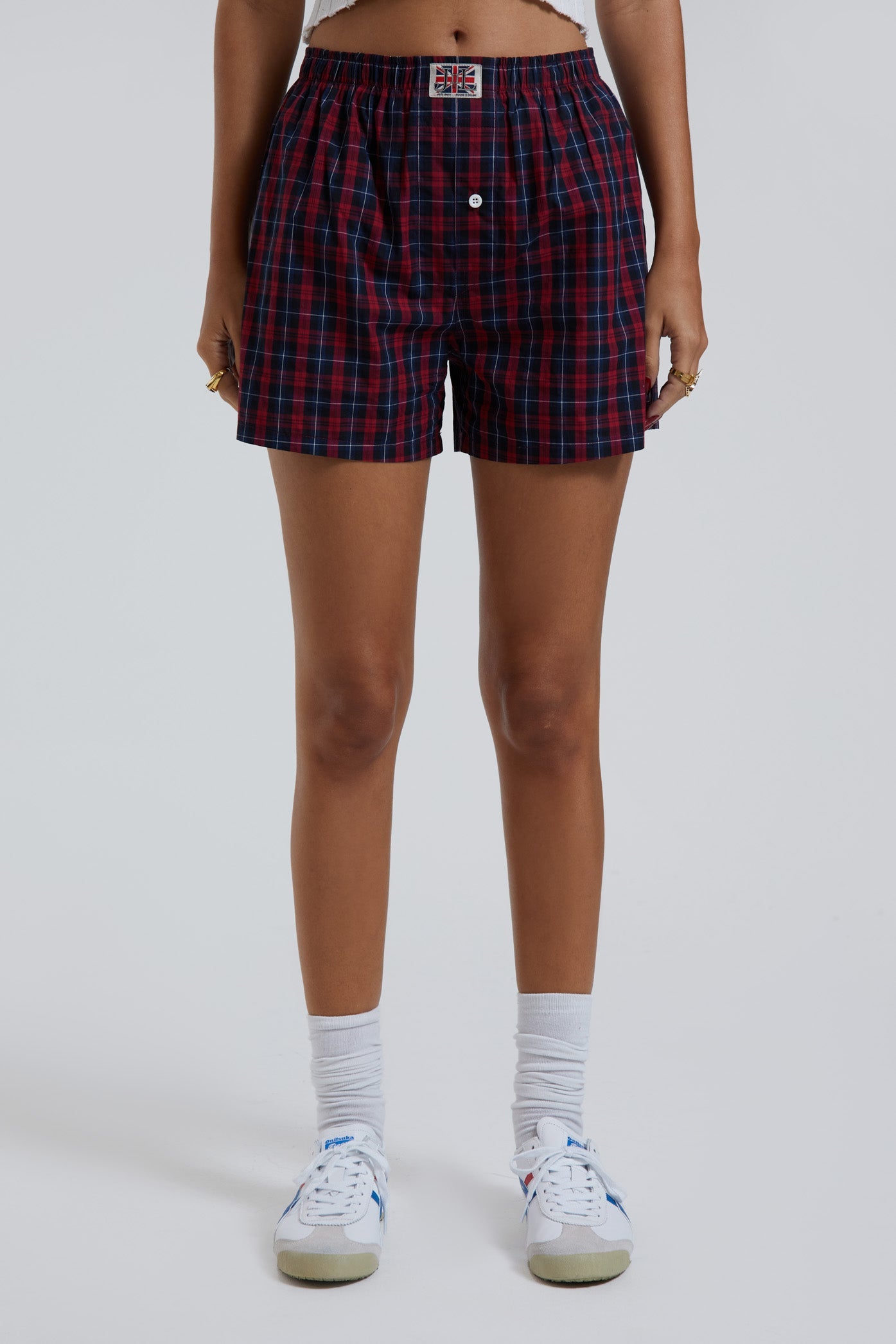 Female wearing blue and green tartan boxer shorts with Union Jack woven label detail.  