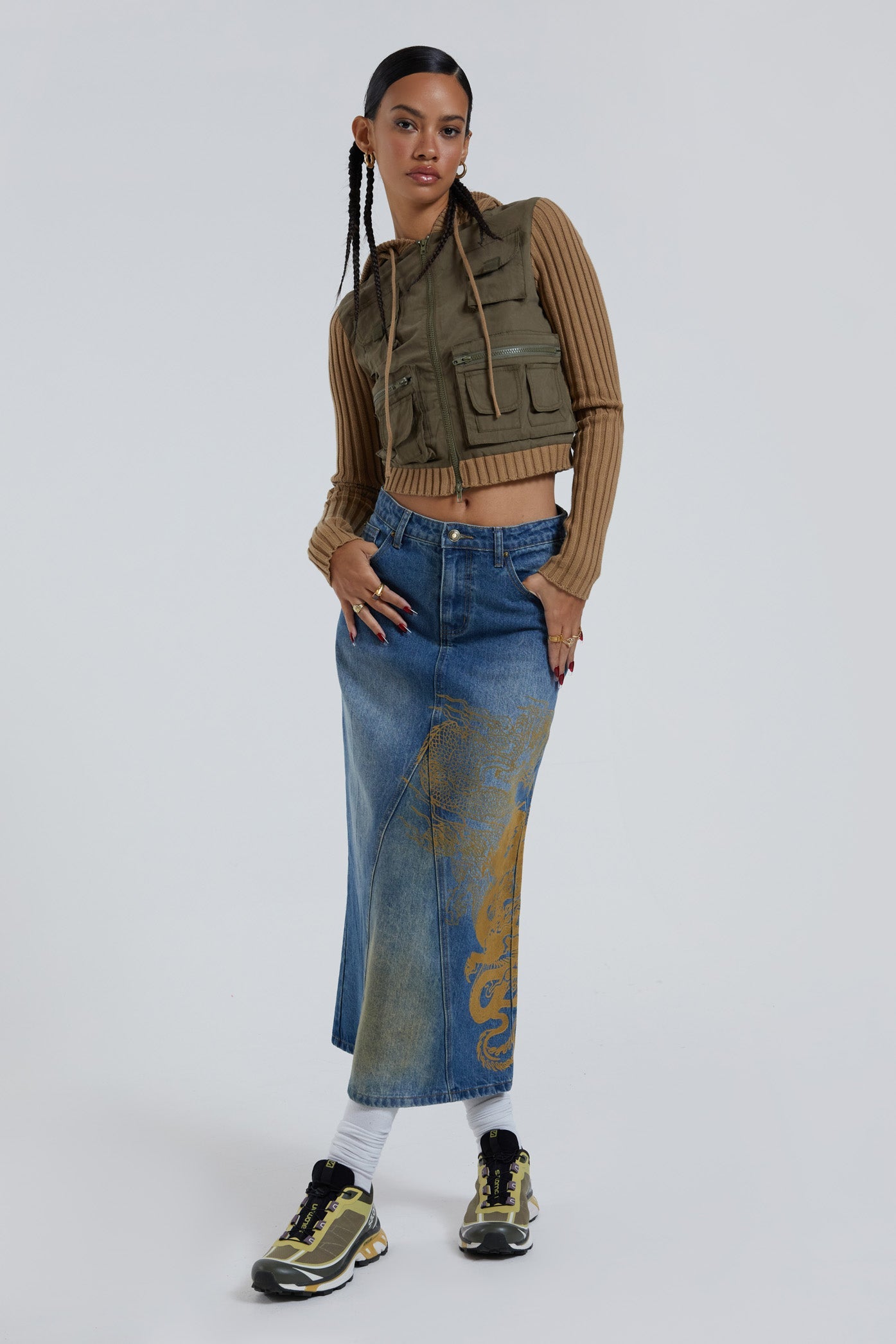 Female wearing sandblast washed denim 00's style maxi skirt with dragon flock print. 