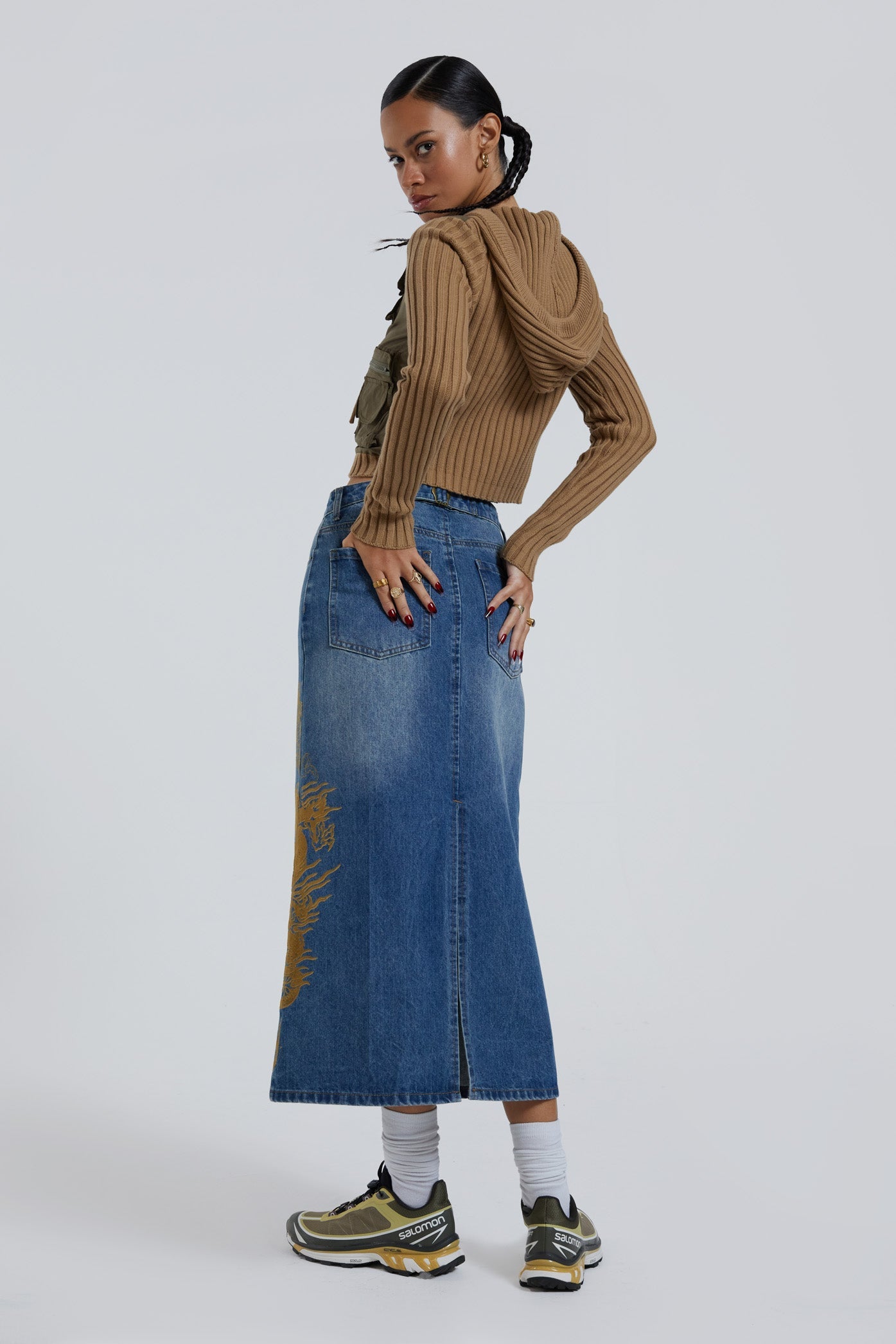 Female wearing sandblast washed denim 00's style maxi skirt with dragon flock print. 