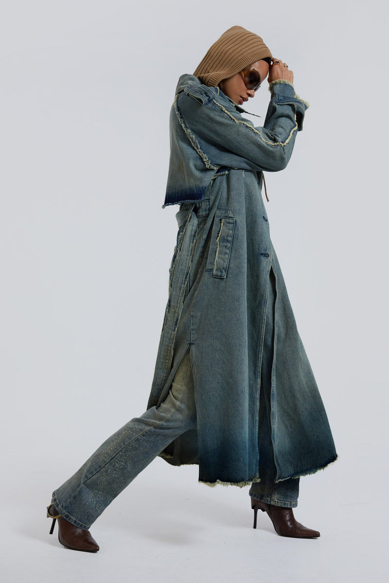 Female wearing blue denim trench style long sleeve parka coat with detachable belt detail. 