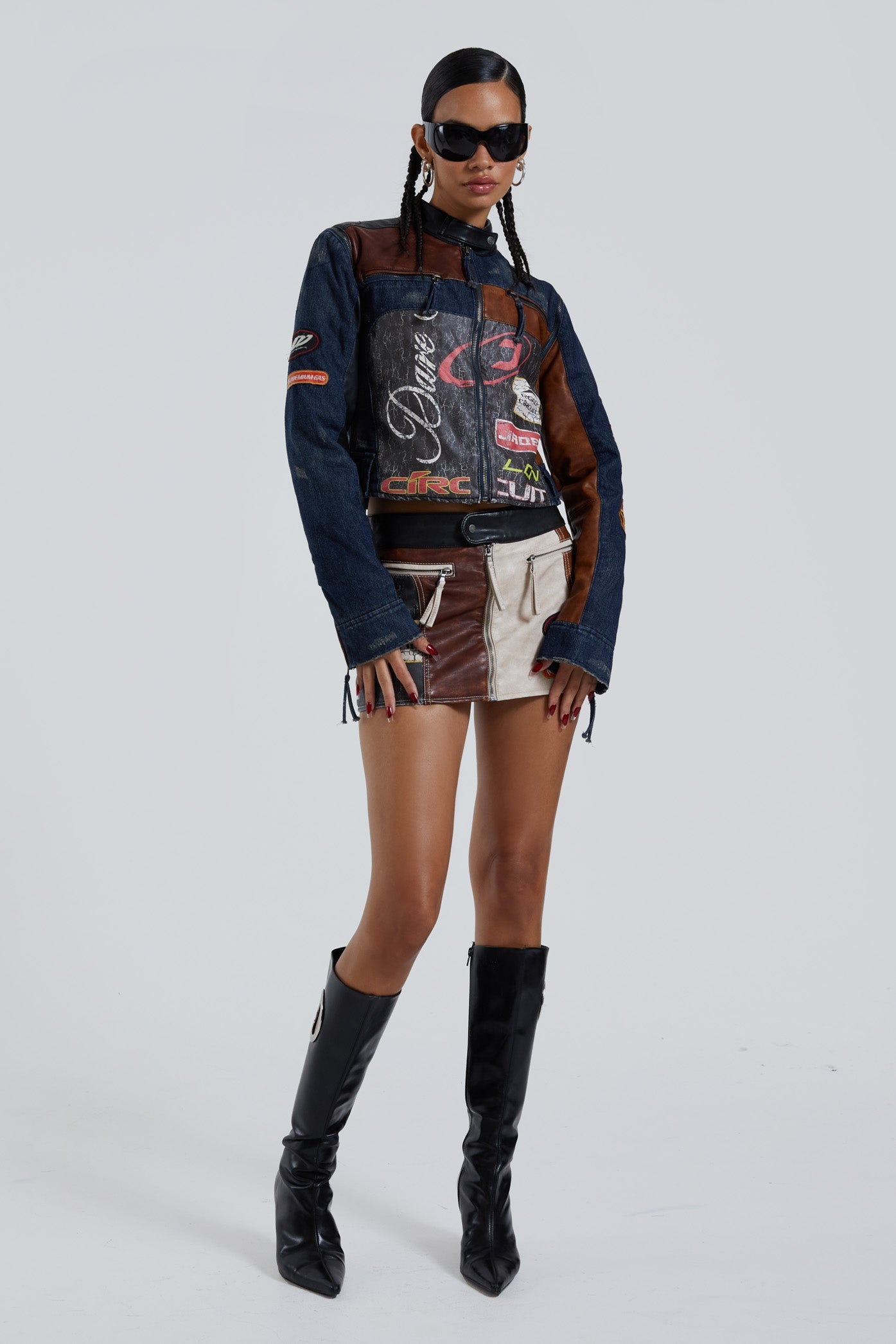 Female wearing denim PU zip up long sleeve moto jacket with embroidery detail. Styled with the matching motto mini skirt. 