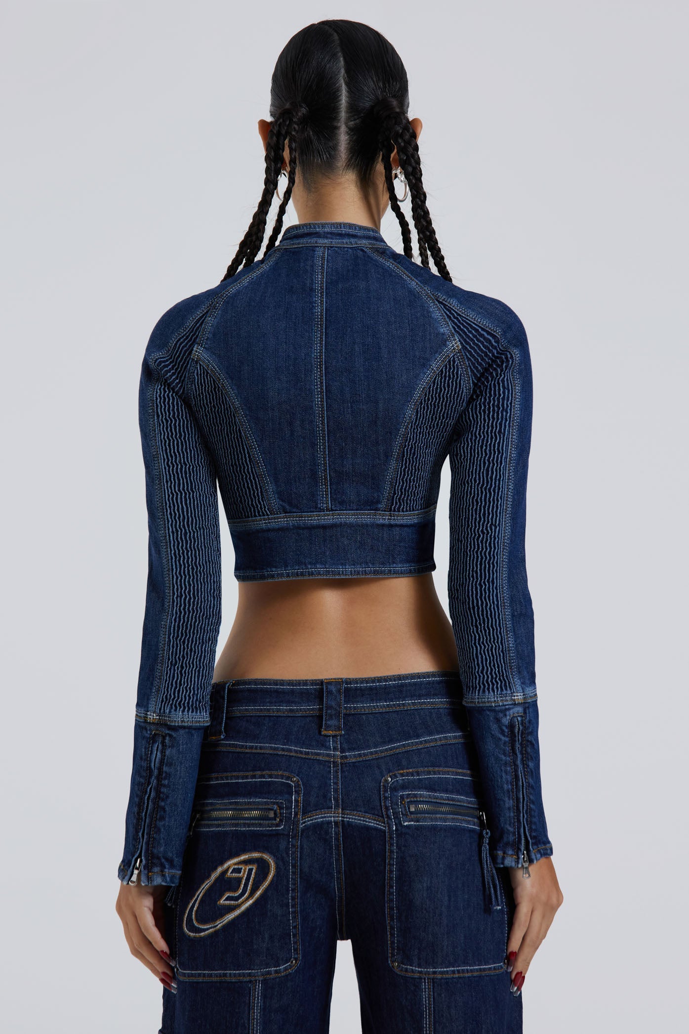 Female wearing blue denim corset motorcycle long sleeve jacket. Styled with the matching denim cargo trousers. 