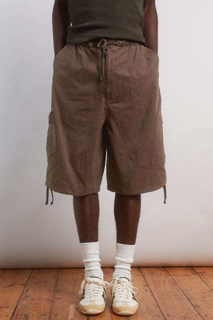 Male wearing Brown Oversized Cargo Shorts.