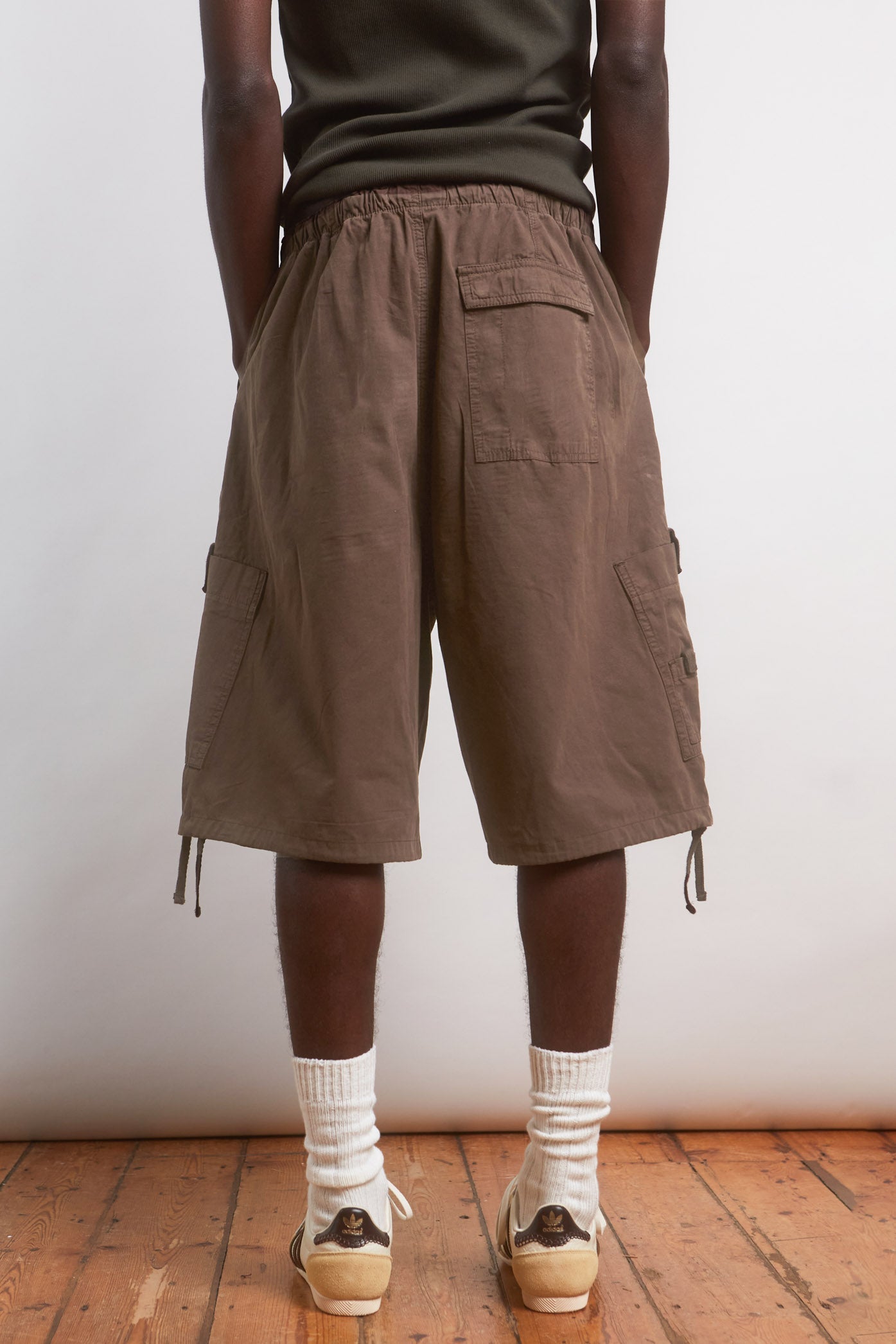 Male wearing Brown Oversized Cargo Shorts.