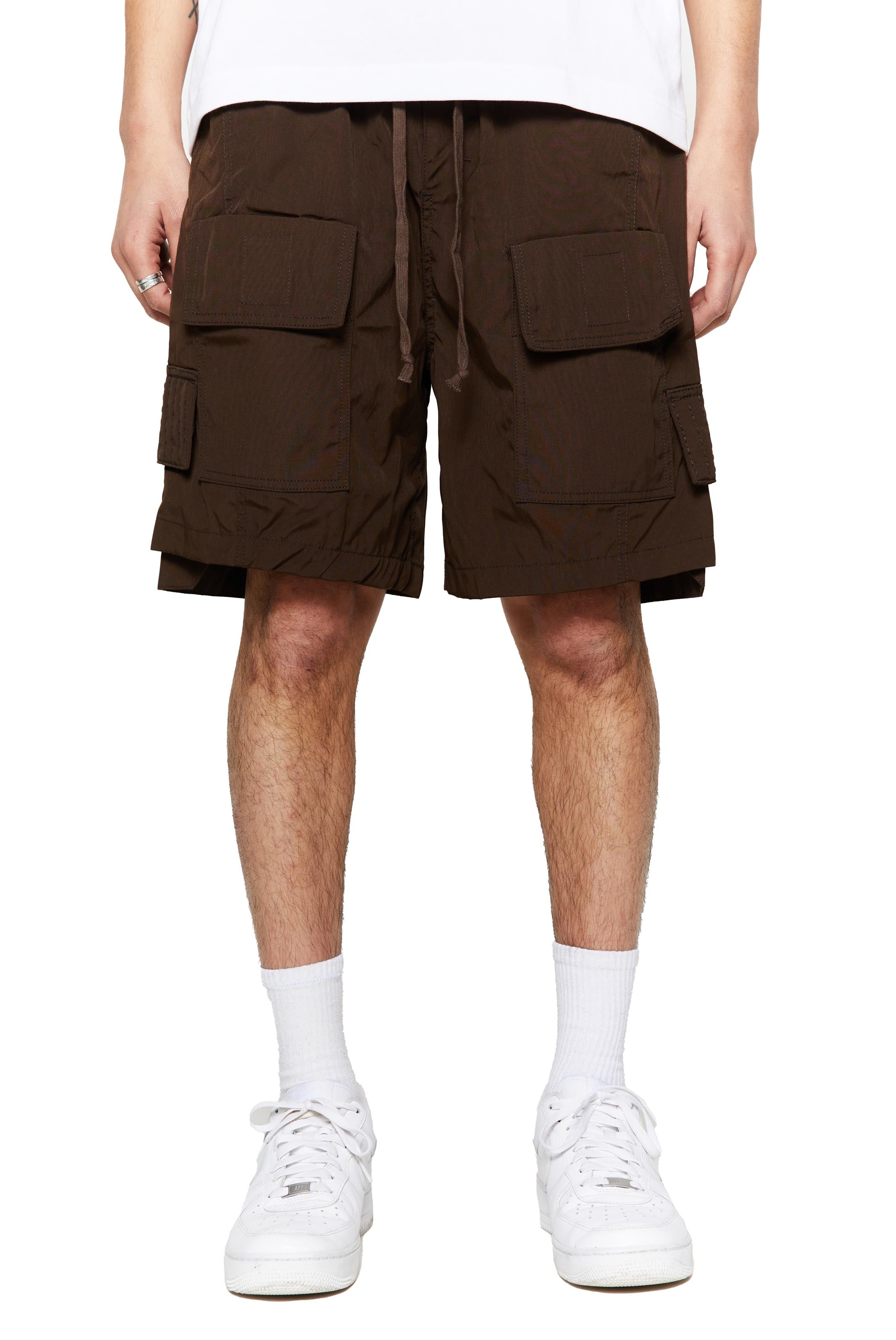 Brown oversized cargo shorts in relaxed fit with ten pocket styling detail. 