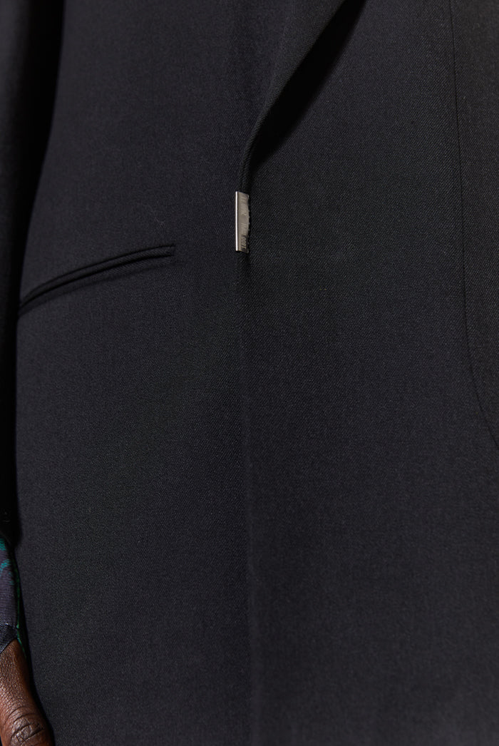 pocket detail of oversized double breasted black blazer