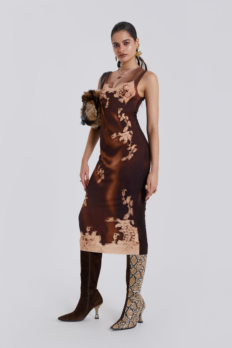 Female model wearing a brown Illusion Lace Slip Maxi Tank Dress. Styled with heels. 