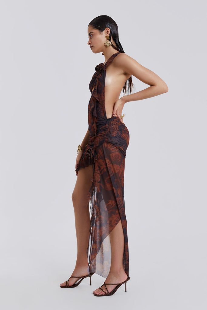 Photo of model wearing Grunge Rose Print One Shoulder Draped Rosette Maxi Dress with cut out detail. Styled with heels. 