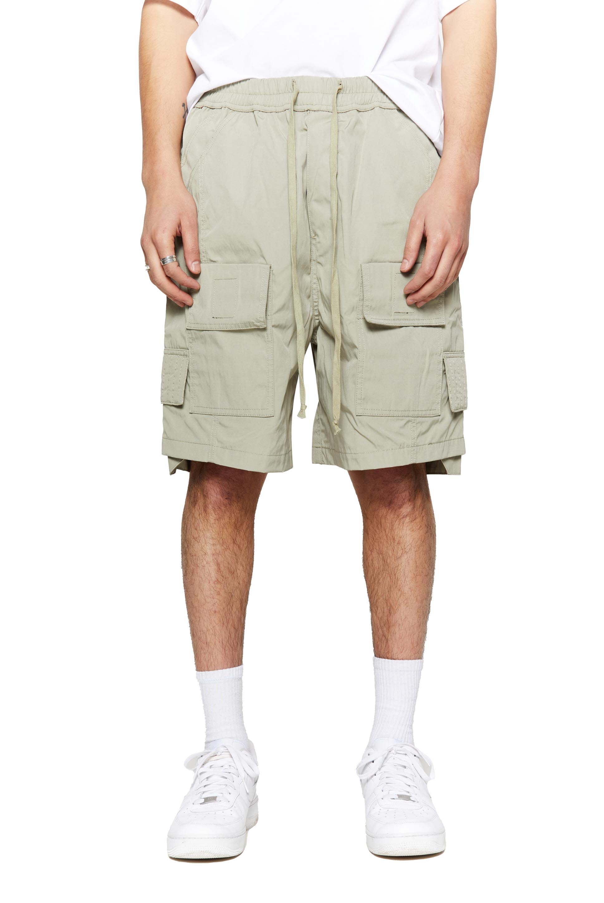 Green oversized cargo shorts in relaxed fit with ten pocket styling detail. 