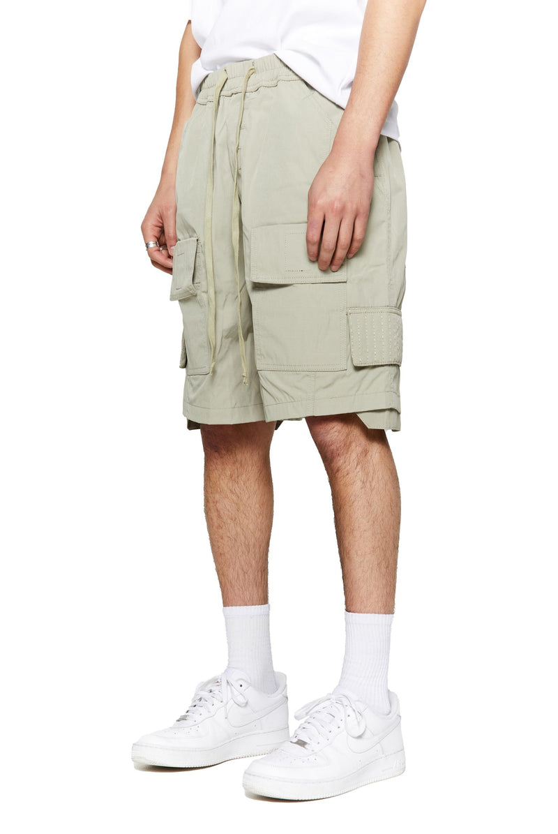 Green oversized cargo shorts in relaxed fit with ten pocket styling detail. 