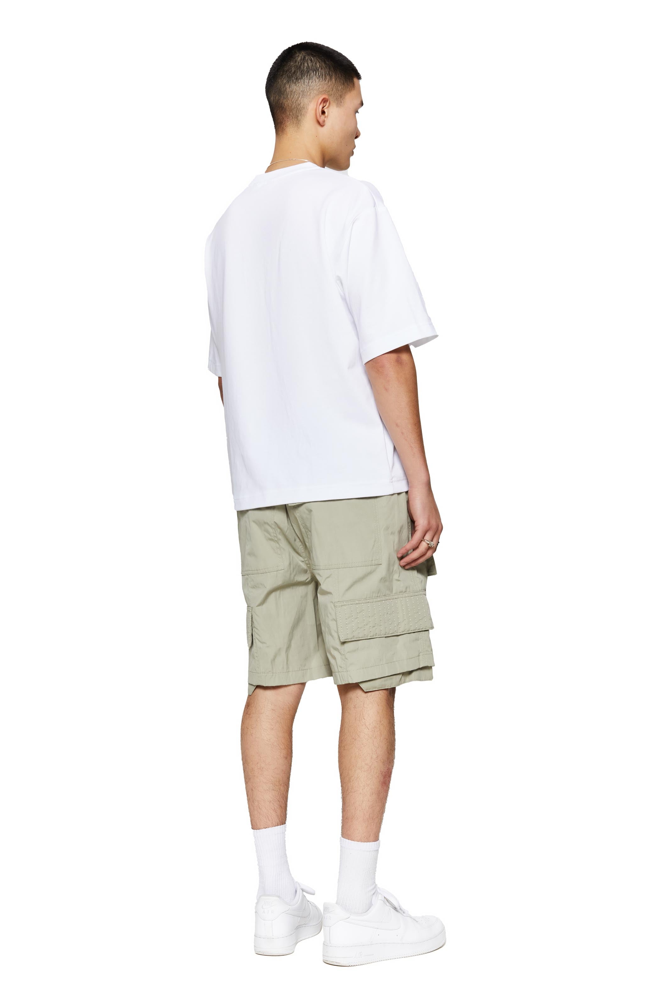 Green oversized cargo shorts in relaxed fit with ten pocket styling detail. 