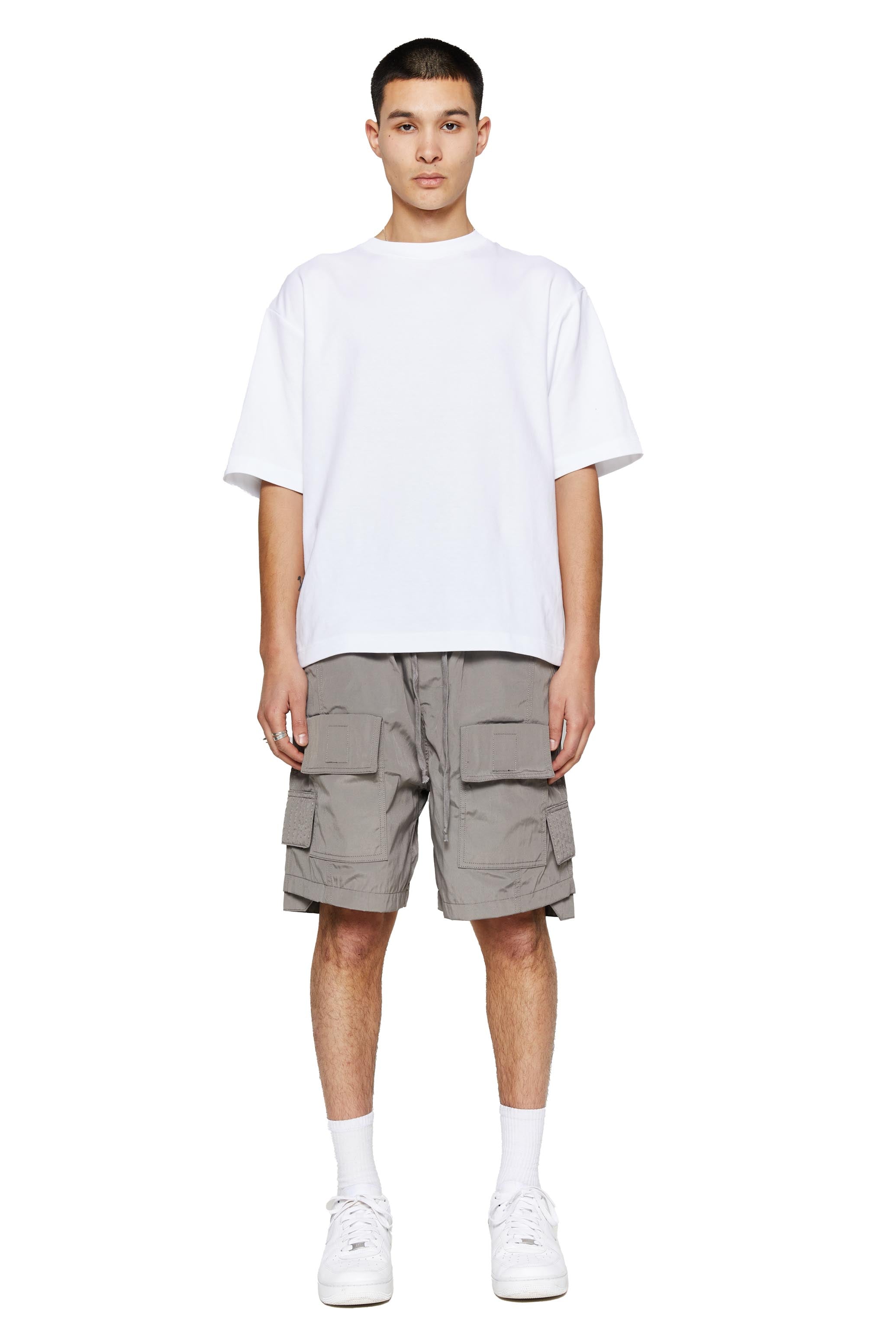 Grey oversized cargo shorts in relaxed fit with ten pocket styling detail. 