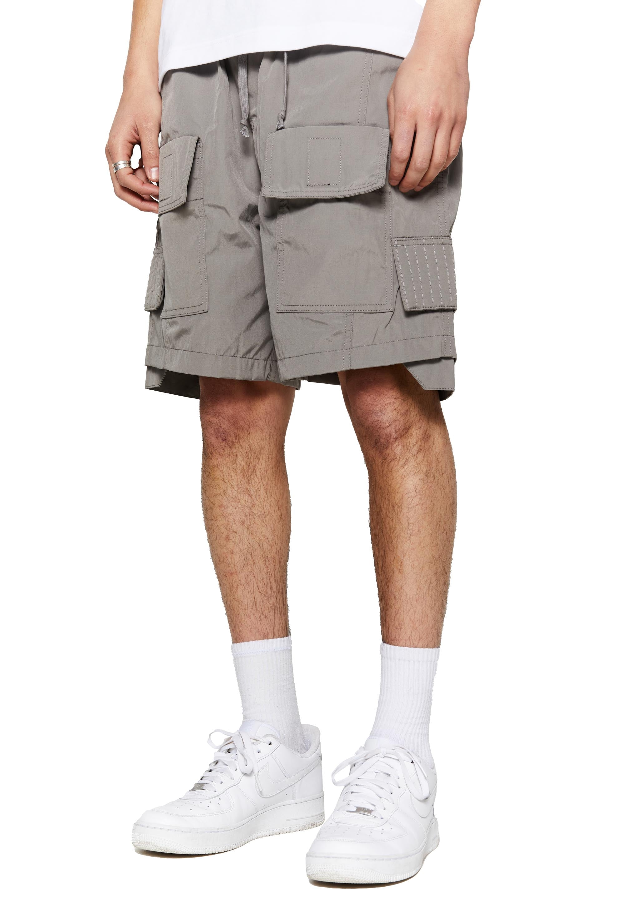 Grey oversized cargo shorts in relaxed fit with ten pocket styling detail. 