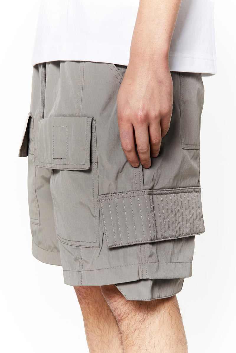 Grey oversized cargo shorts in relaxed fit with ten pocket styling detail. 