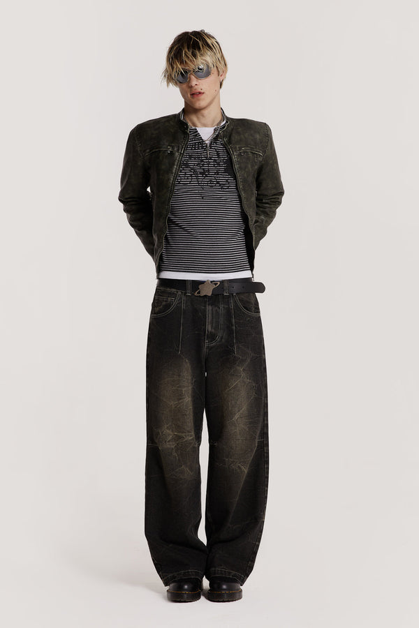 Male model wearing washed black jeans in an ultra wide leg fit. 
