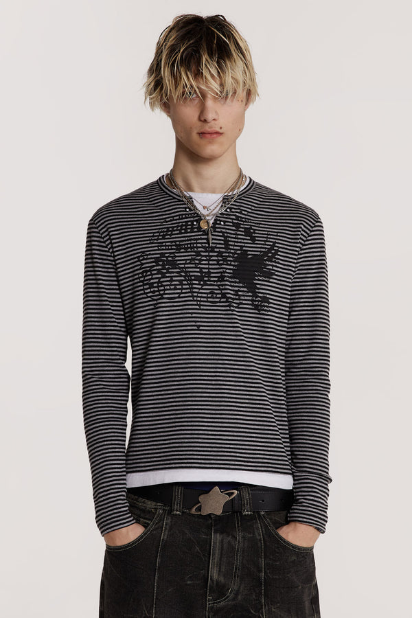 Male model wearing a grey tonal long sleeved striped jersey top designed with a lace up front and tonal screen print on the chest.