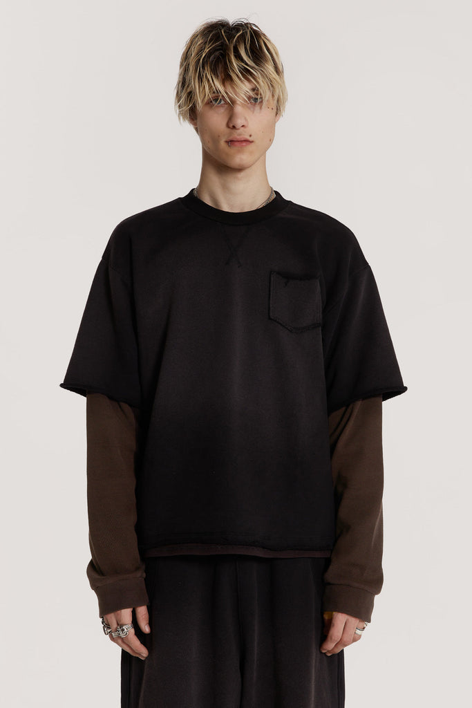 Male model wearing a black double layer top is crafted in a heavy sweat and waffle jersey fabric with a double layer finish.