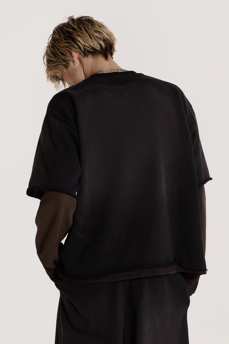 Male model wearing a black double layer top is crafted in a heavy sweat and waffle jersey fabric with a double layer finish.