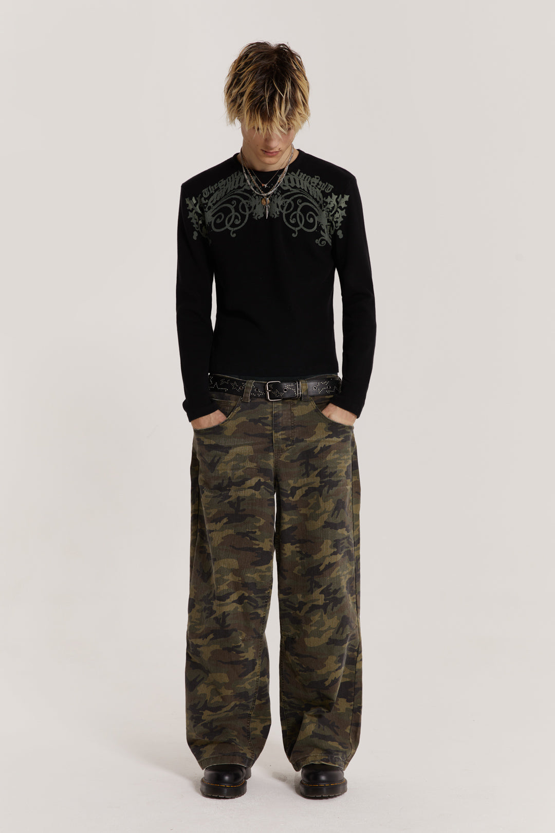  Male model wearing green camouflage print denim jeans in Colossus fit. 