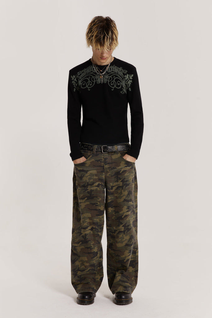  Male model wearing green camouflage print denim jeans in Colossus fit. 