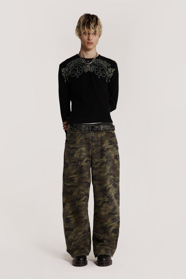  Male model wearing green camouflage print denim jeans in Colossus fit. 