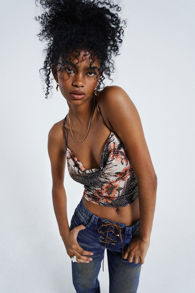 Female wearing Floral Print Cowl Neck Cami Top. Styled with washed blue lace up jeans.