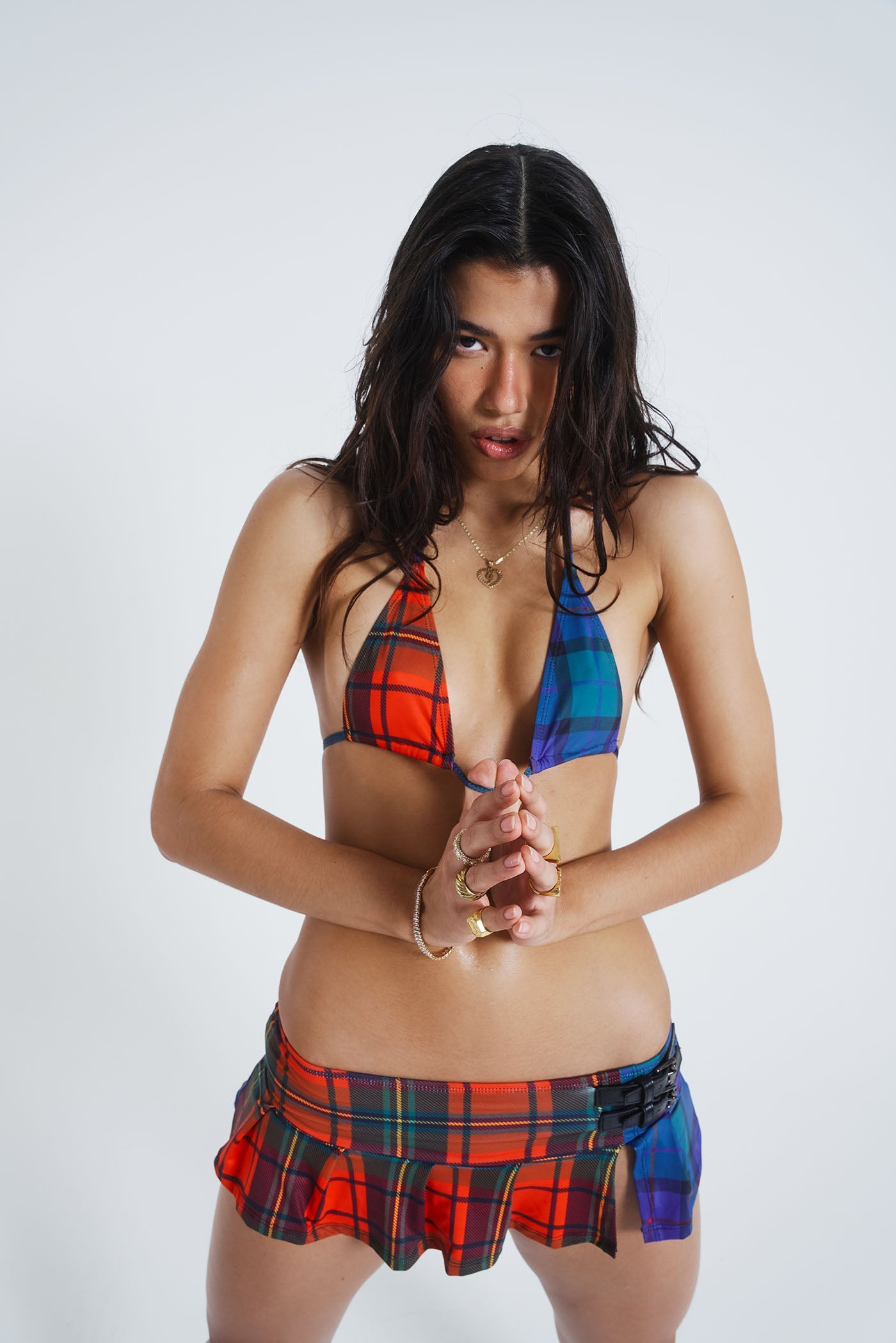 Female model wearing red, blue & green Mixed Tartan Print Kilt Bikini Bottoms. Styled with the matching bikini top.  