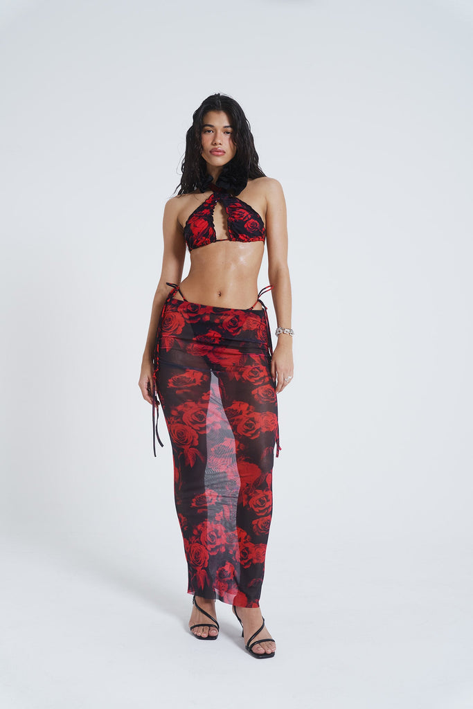 Female model wearing Gothic Floral Print Mesh Maxi Skirt. Paired with the matching halterneck bikini top. 