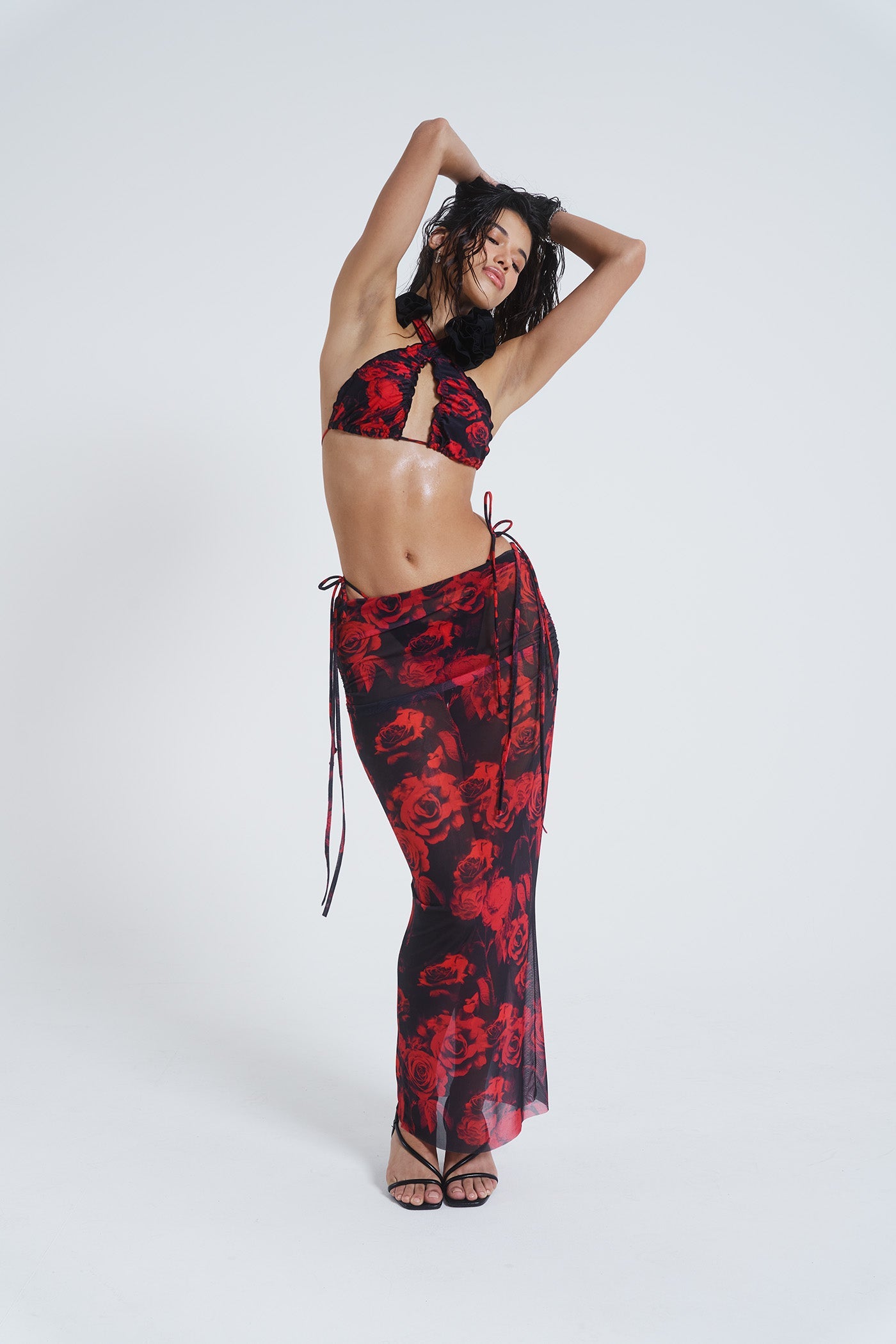 Female model wearing Gothic Floral Print Mesh Maxi Skirt. Paired with the matching halterneck bikini top. 