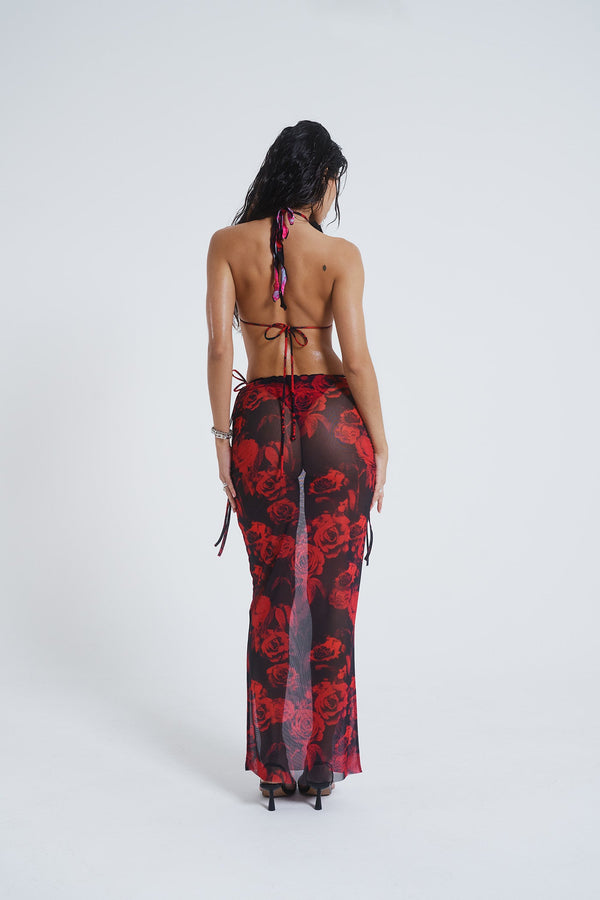 Female model wearing Gothic Floral Print Mesh Maxi Skirt. Paired with the matching halterneck bikini top. 