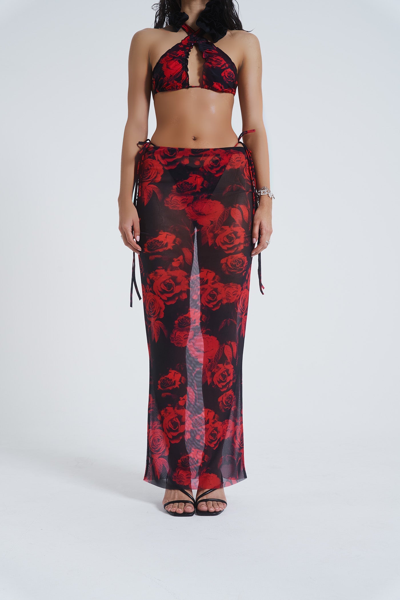 Female model wearing Gothic Floral Print Mesh Maxi Skirt. Paired with the matching halterneck bikini top. 