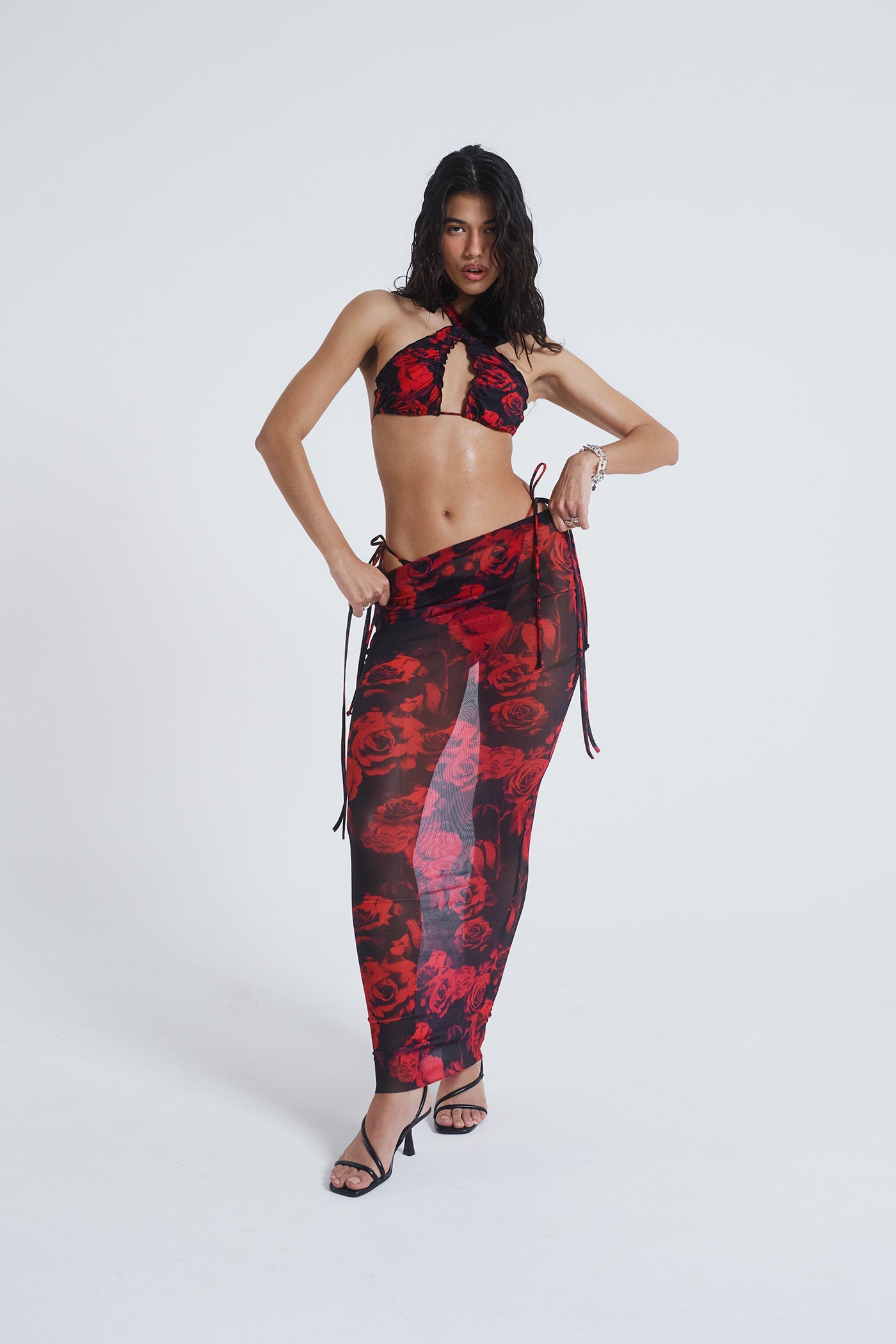 Female model wearing Gothic Floral Print Mesh Maxi Skirt. Paired with the matching halterneck bikini top. 