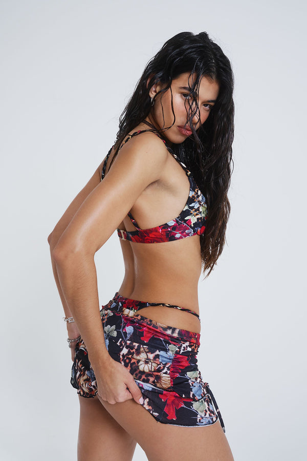 Female model wearing Dark Romantic Leopard Print Rara Skirt. Styled with the matching balcony cup bikini top. 