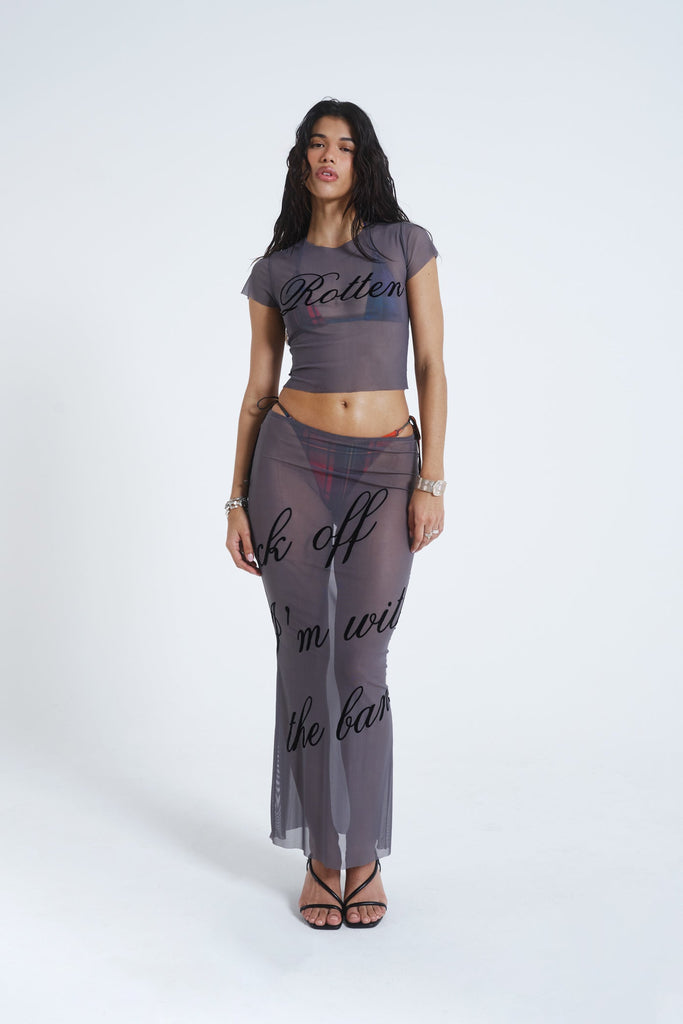 Female model wearing grey lightweight mesh t-shirt features a “rotten” black flock placement print. Paired with the matching mesh maxi skirt. 