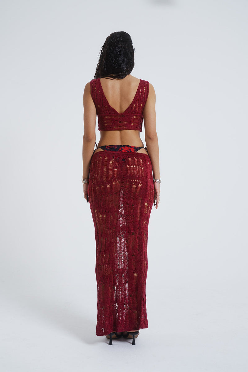 Female model wearing Burgundy Laddered Knit Maxi Skirt. Paired with the matching knitted crop top. 