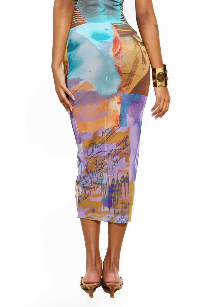Female model wearing the Statue Mix Print Mesh Column Maxi Skirt. Styled with the matching bandeau slashed swimsuit. 