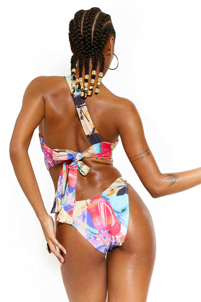 Female model wearing Mix Statue Print Asymmetric Bikini Top in multicolour. Styled with the matching high waist bikini bottoms. 