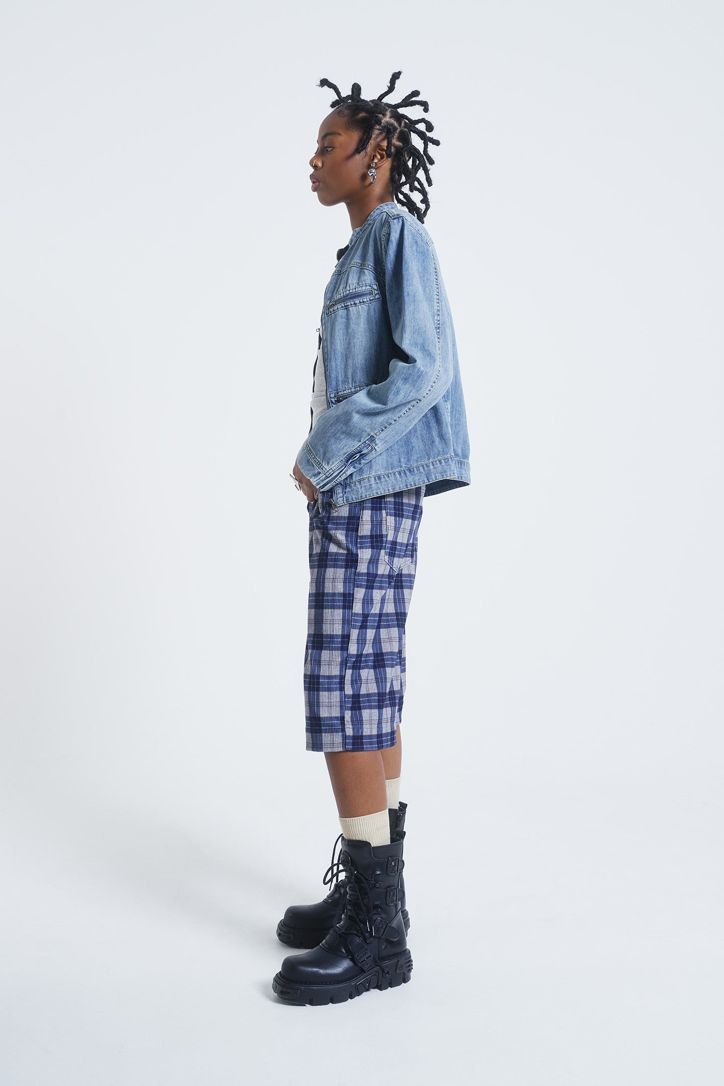 Female model wearing blue checked cord jorts in a jumbo fit. 