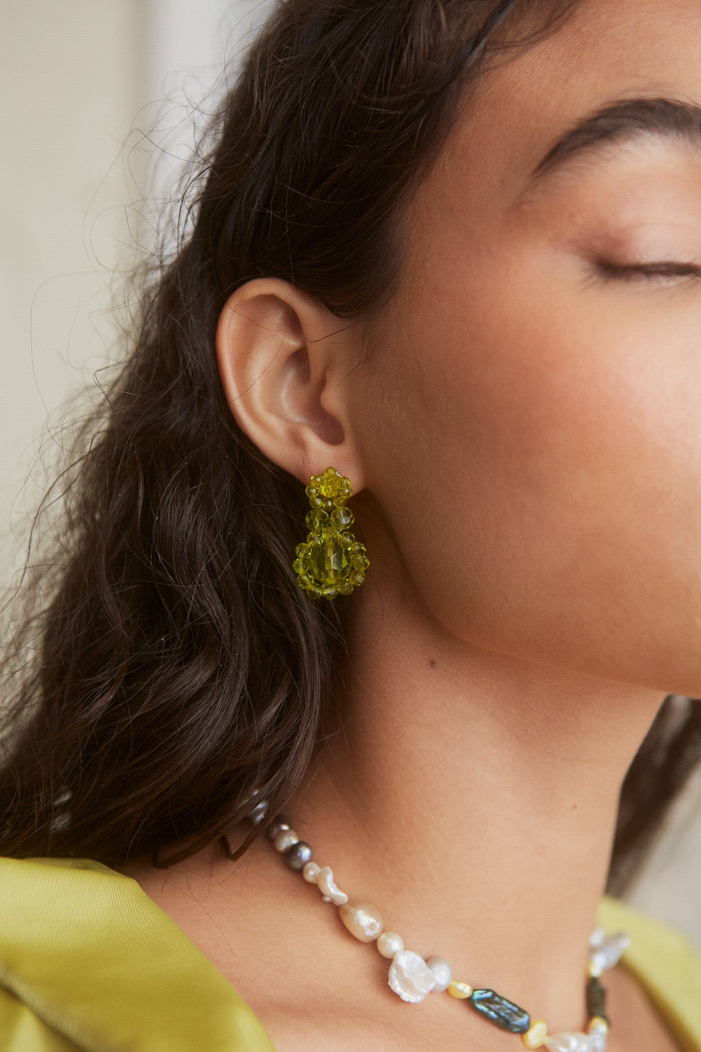 Female wearing Green Resin Flower Beaded Earrings. 