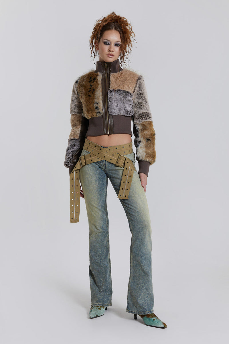 Female model wearing a patchwork faux fur bomber jacket with a ribbed collar and cuffs. 