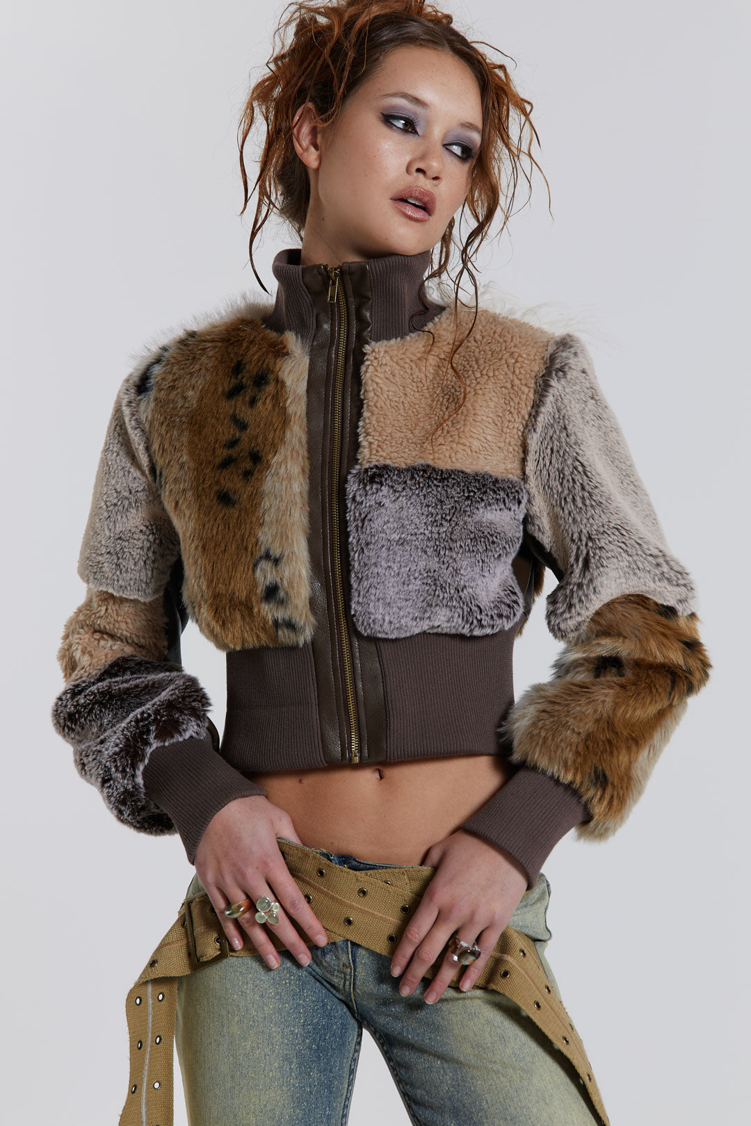 Female model wearing a patchwork faux fur bomber jacket with a ribbed collar and cuffs. 