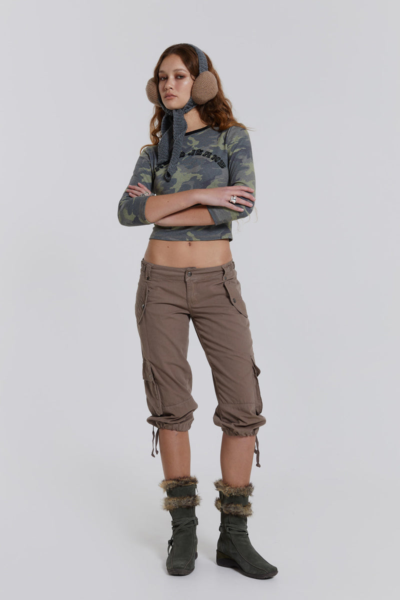 Female model wearing walnut cropped cargo trousers with a drawcord hem detail. Paired with a check corset top. 