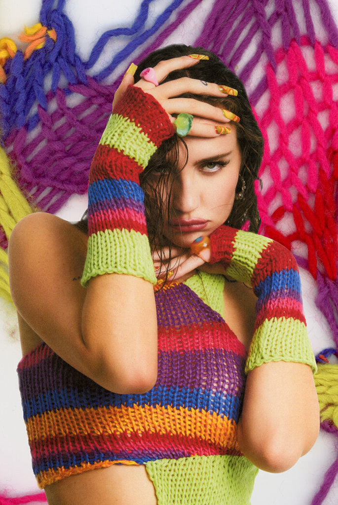 Close up detail of coloured knitwear gloves and top