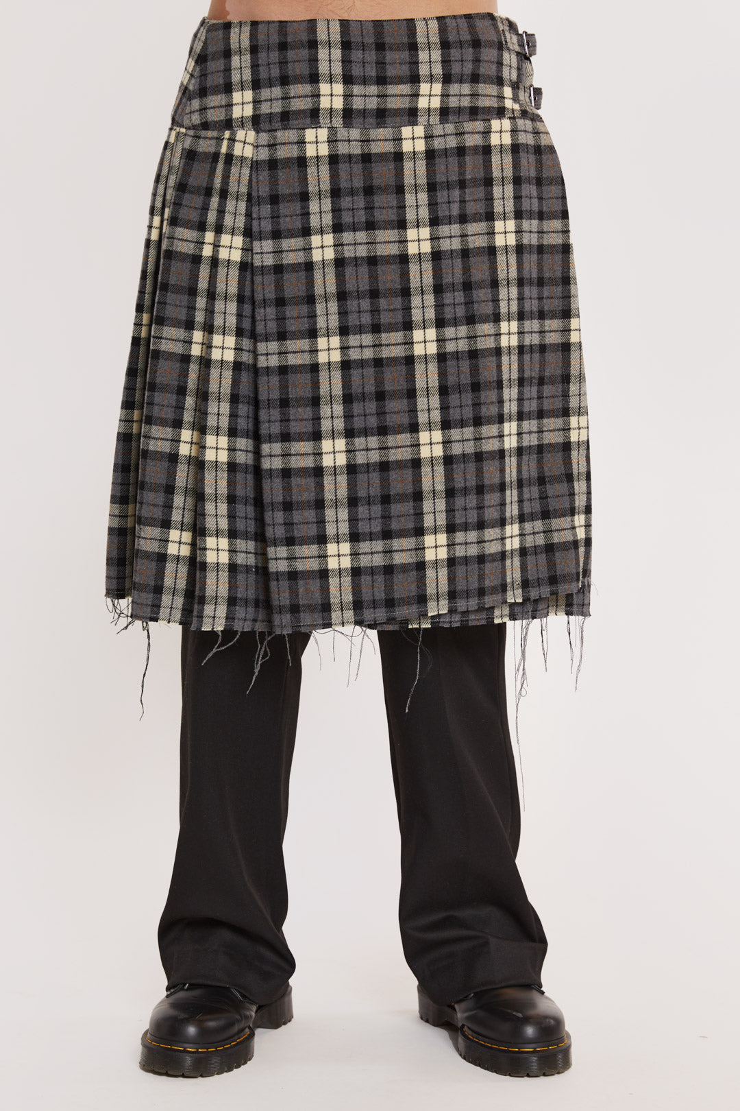 Male wearing Grey Checked Kilt. Styled with black suit trousers and white shirt. 