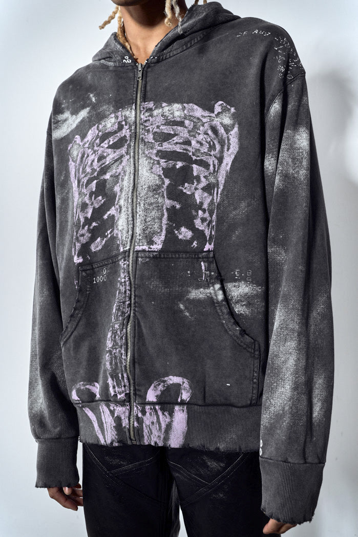 Close up of acid wash black zip up hoodie with ribcage print